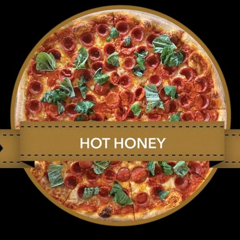 Mikey's Pizza Hot Honey pepperoni pizza with fresh basil on a black background.